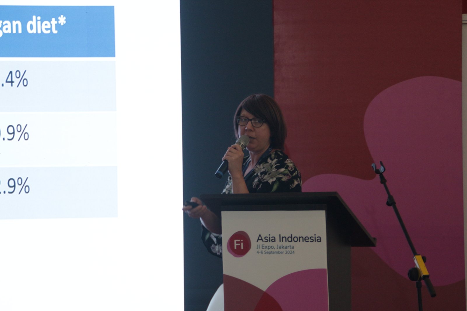 Speaker presenting dietary research data on screen