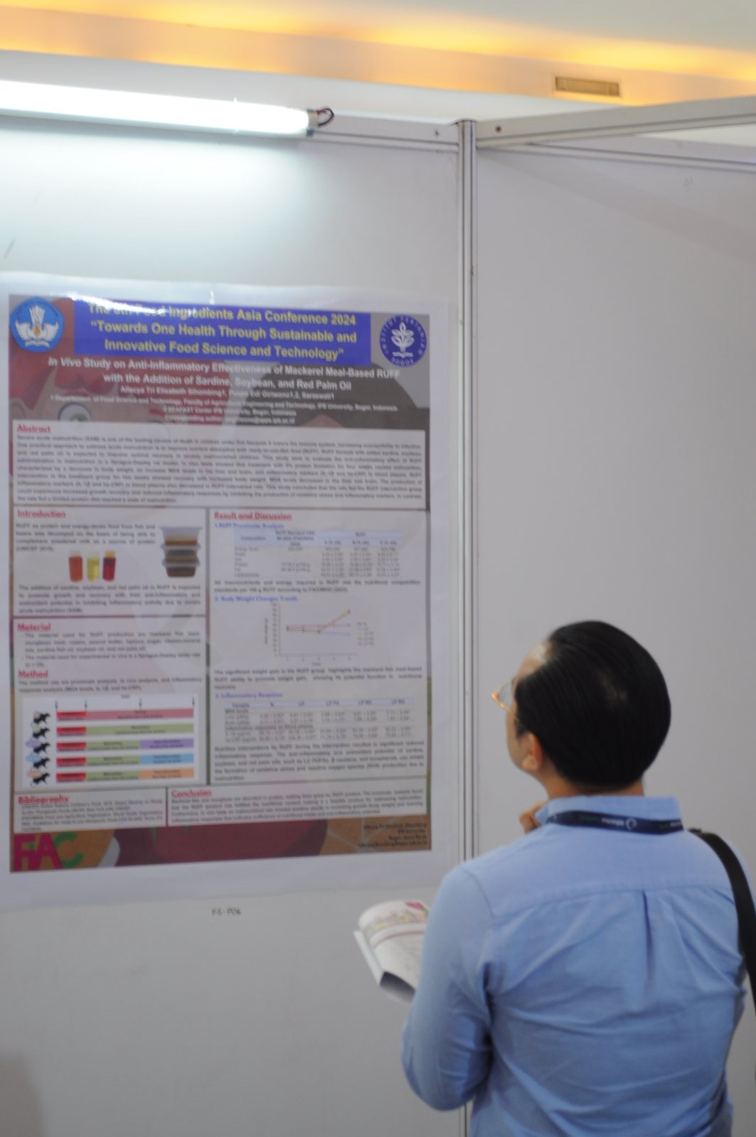 Poster presentation session with presenters and reviewers